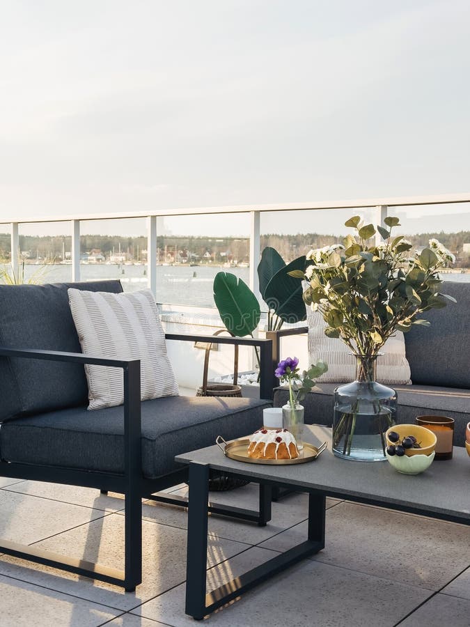 Modern rooftop patio with outdoor furniture and city view